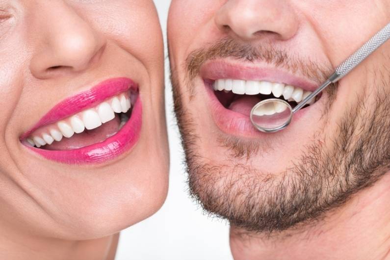 Woman and man smiling with beautiful healthy teeth