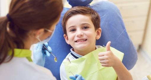 A Child with a Dentist in a Dental Office.