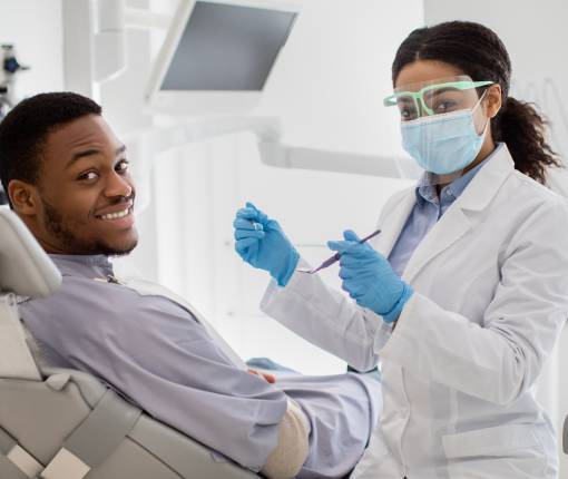 Female Dentist Having Treatment with Male Patient